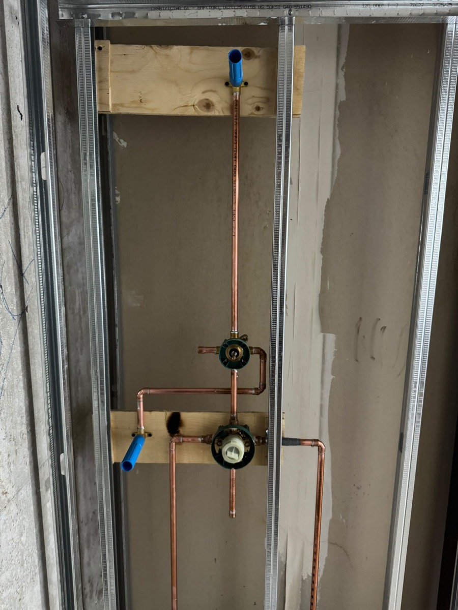 Copper shower valve rough-in inside a framed wall