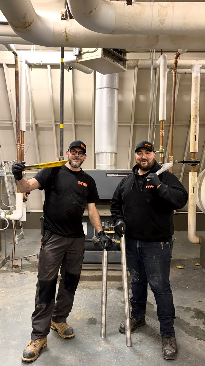 Two Ridgewood Mechanical technicians in a mechanical room