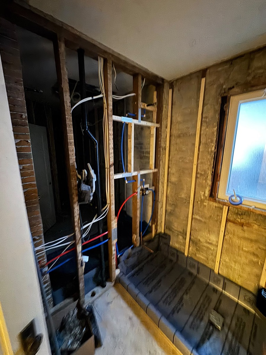 Bathroom rough-in in an older house with the walls opened