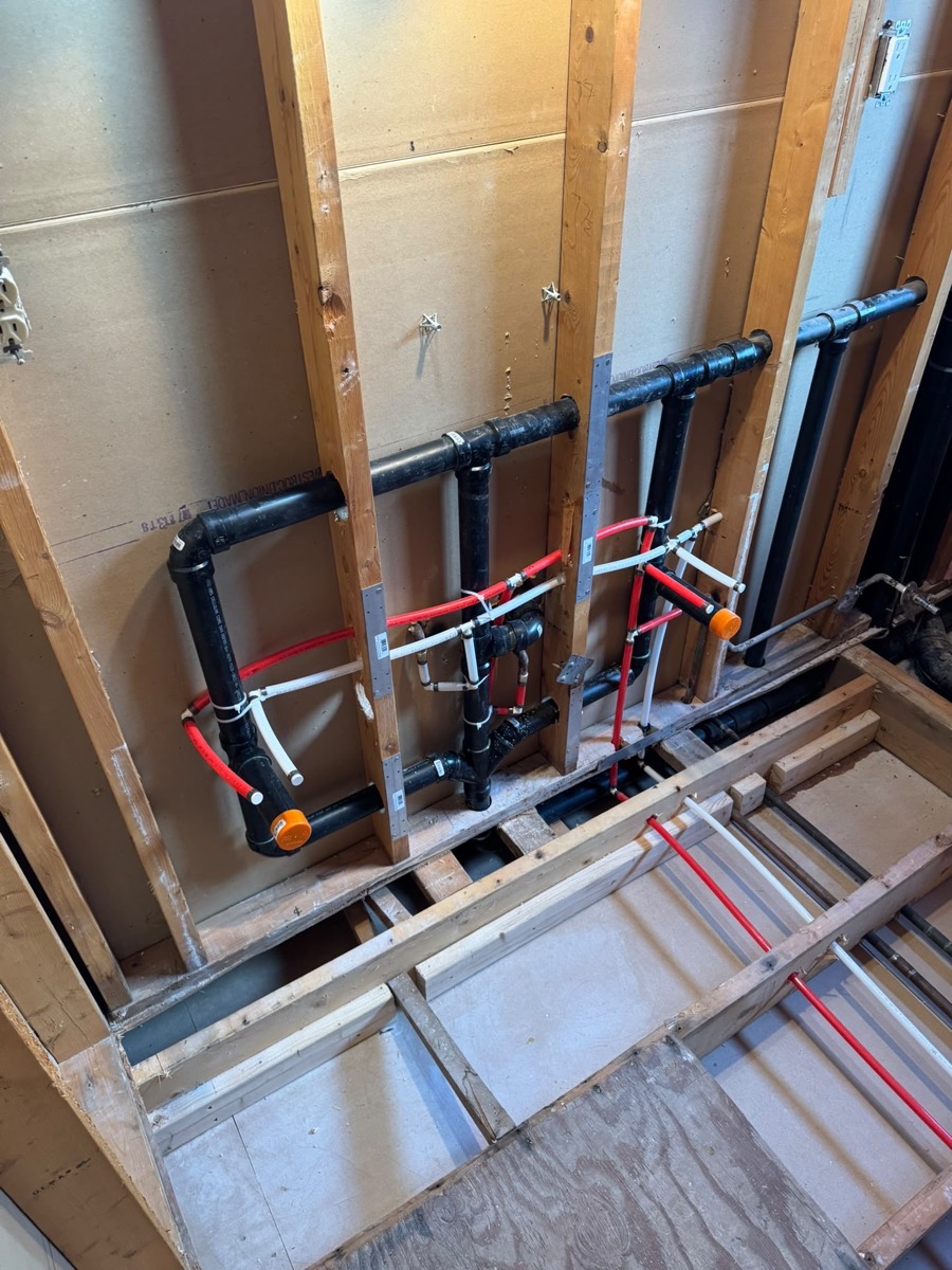PEX manifold and supply lines roughed in between studs