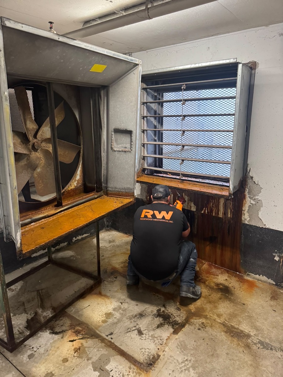 Technician working inside a mechanical fan room