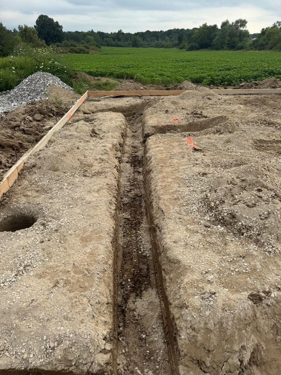 Trench for a new water line running across a rural lot
