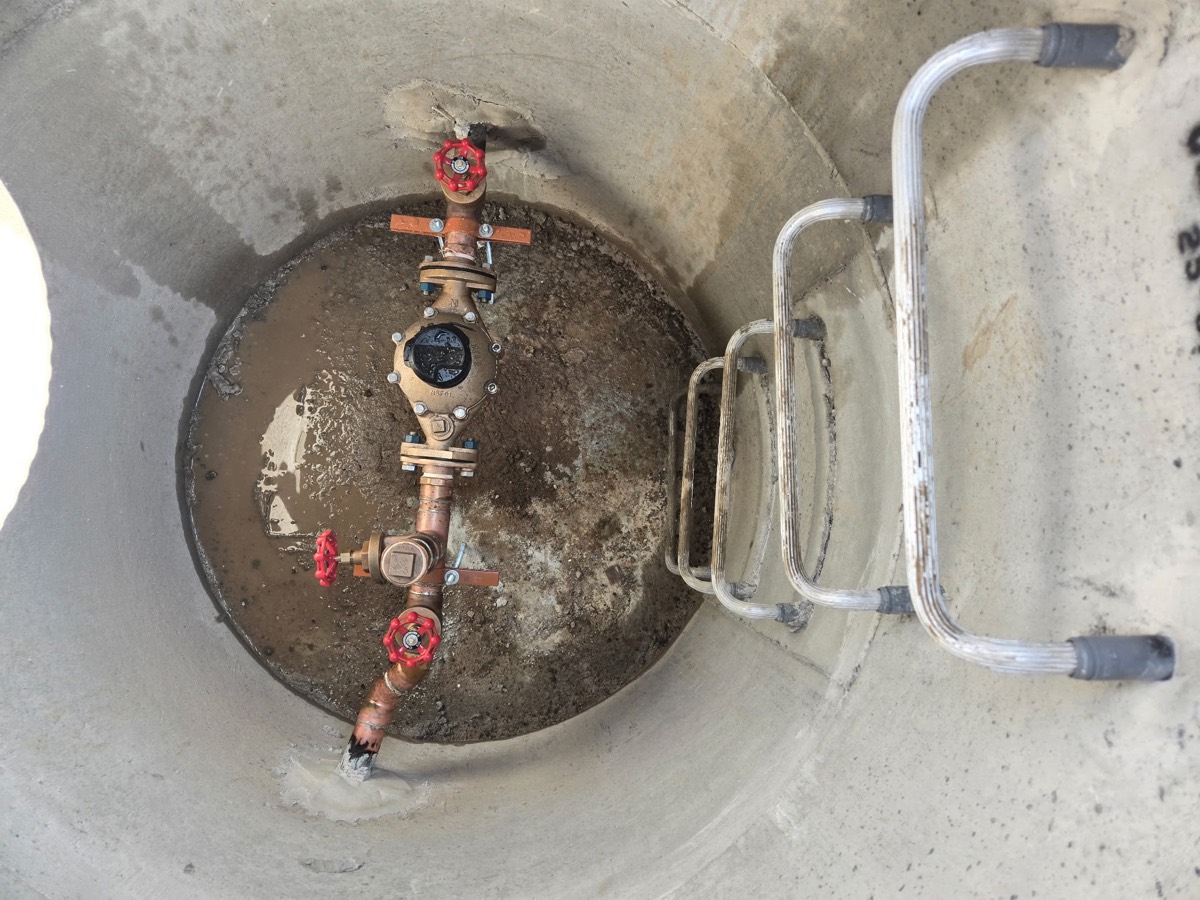 Looking down into a water service chamber at the valve assembly